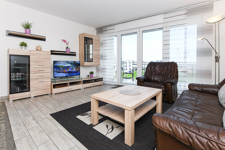 Ferienwohnung „Nordseekieker“ - Wohnzimmer mit integriertem Küchenbereich