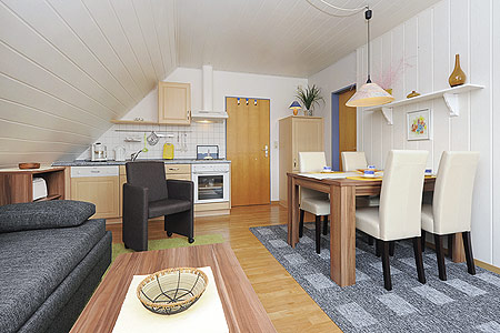 Ferienwohnung „Spiekeroog“ - Wohnraum mit integrierter Küche und Essgruppe