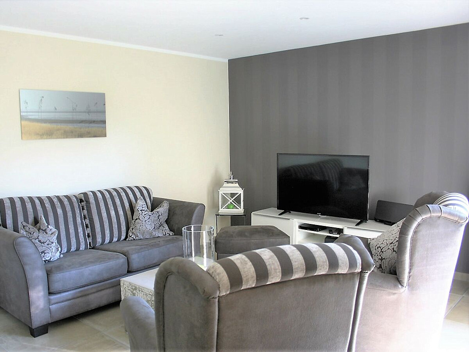 Ferienhaus „Küstenhaus Wremen“ - Wohnzimmer mit Kamin