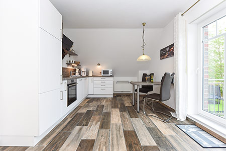 Ferienwohnung „Wattwürmchen“ - Wohnzimmer mit integriertem Küchenbereich