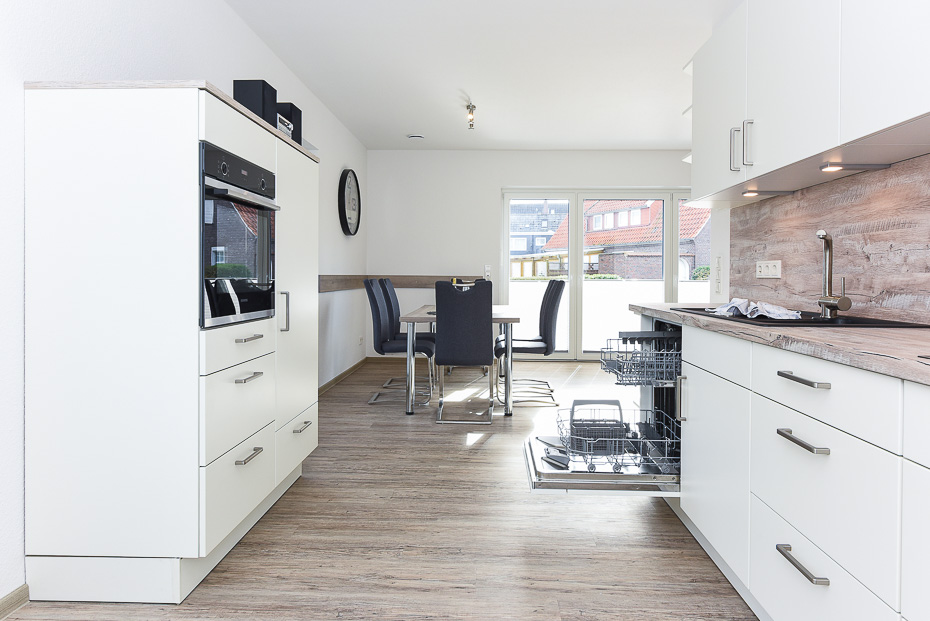 Ferienhaus „Strandperle“ - Wohnraum mit integrierter Küche und Essgruppe