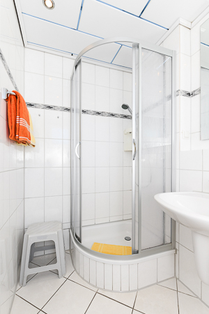 Ferienhaus „Friesenperle“ - Badezimmer mit Dusche, Waschtisch und WC